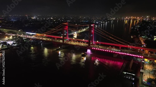 Aerial shot of Ampera Bridge at night, one of the landmarks of Palembang city, South Sumatra, Indonesia photo