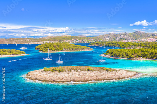 A breathtaking aerial view of the Pakleni Islands, Hvar, featuring the secluded Mlini Beach, surrounded by lush Mediterranean nature, making it a top sailing and summer getaway destination