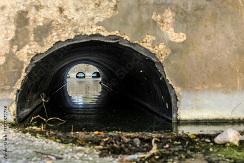 Foto close-up of an old culvert system under a roadway to help prevent water from pooling