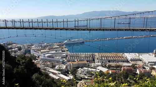 A stunning panoramic view showcasing the Windsor Suspension Bridge, set against the breathtaking backdrop of the Port of Gibraltar and the Bay of Algeciras.