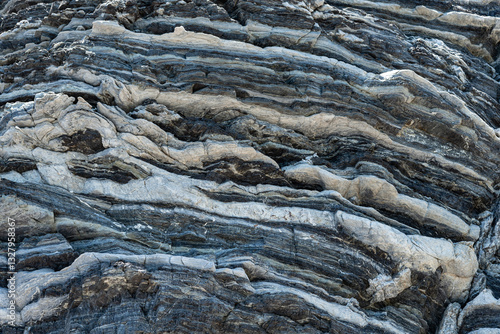 Compressed rock layers formation in various colors and thicknesses, on south central coast of the Mediterranean island Crete, Greece. Nature and Geological science concept