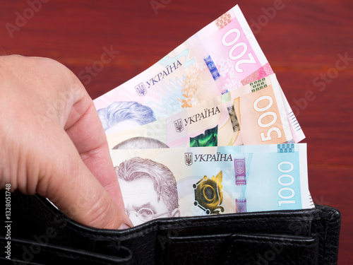 Ukrainian hryvnia in the black wallet photo