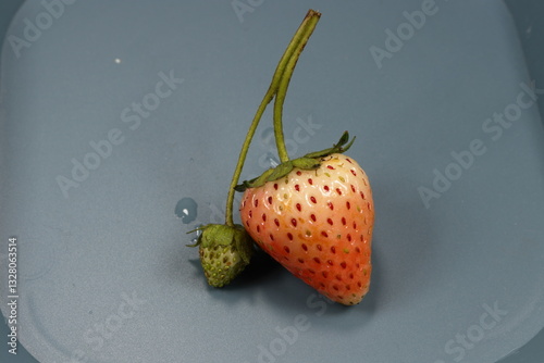 strawberry on a blue background. Mock up of tropical fruit.
