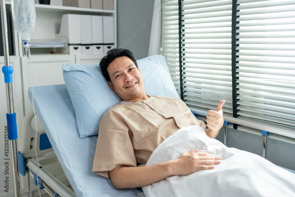Obraz premium Portrait of young man patient lying on hospital bed in recovery room.
