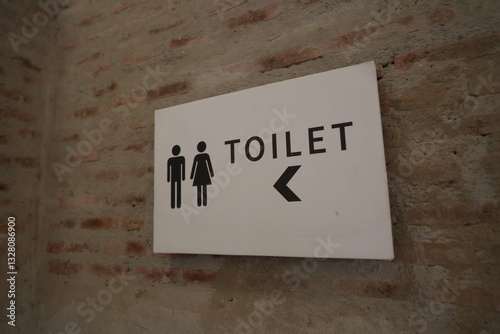 Restrooms sign with arrow