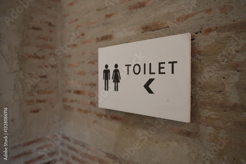 Restrooms sign with arrow
