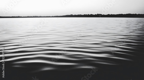 Serene Lake Scene With Calm Water and Distant Horizon, black and white landscape view