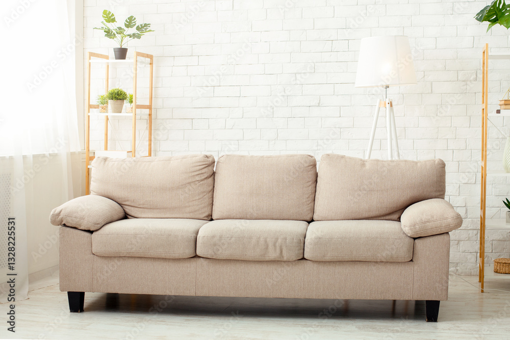 Fototapeta premium Minimalist style. Modern living room with sofa, plants and window in daylight, free space