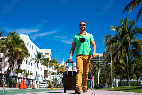 Photography A traveler walks through the sunny streets of Miami