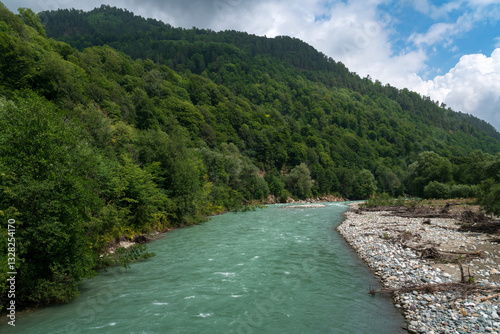 View of the Bolshoy Zelenchuk River in the northern foothills of the Caucasus Mountains near the village of Nizhny Arkhyz on a summer day, Karachay-Cherkessia, Russia photo