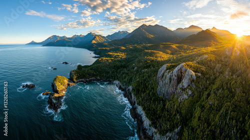 Obraz na płótnie stunning aerial view of majestic mountain range meeting vast ocean, illuminated by golden sunlight, evokes feelings of serenity and freedom w salonie