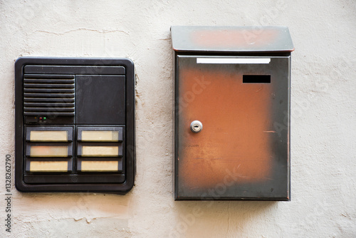 Speaker phone on wall mount and letter box at house
