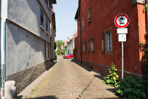 Fototapeta Naklejka Na Ścianę i Meble -  German people driving red sport car come in small alley in Ladenburg town, Germany