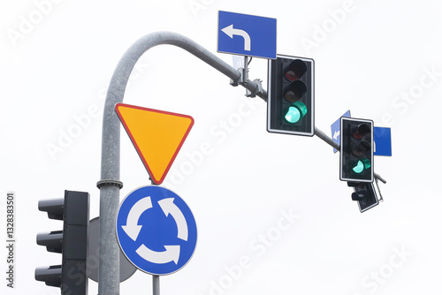 Green traffic light at an intersection on a cloudy day. Road safety and transportation control signal. Urban street scene guiding vehicles and pedestrians.
