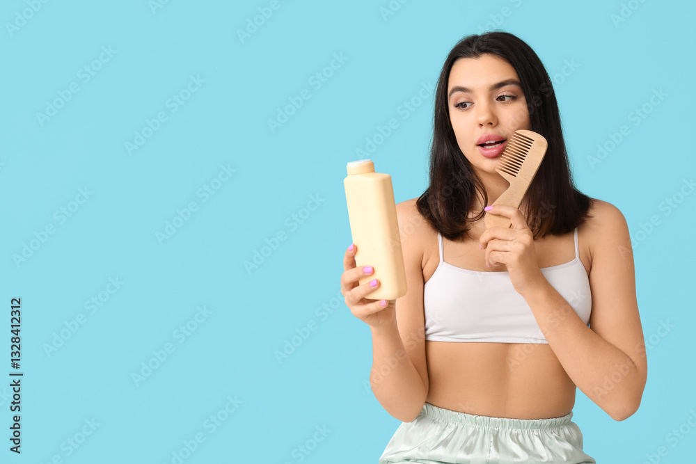 Beautiful young woman with bottle of cosmetic product and hair comb on color background Beautiful young woman with bottle of cosmetic product and hair comb on color background