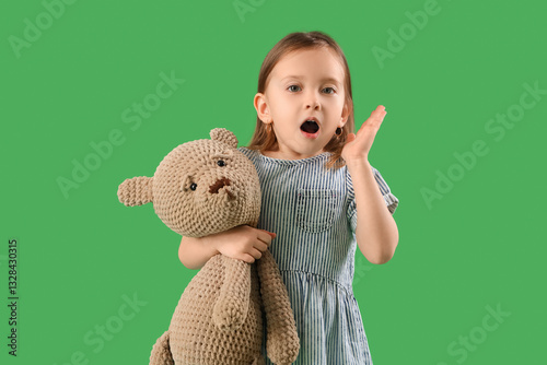 Shocked little girl with te...