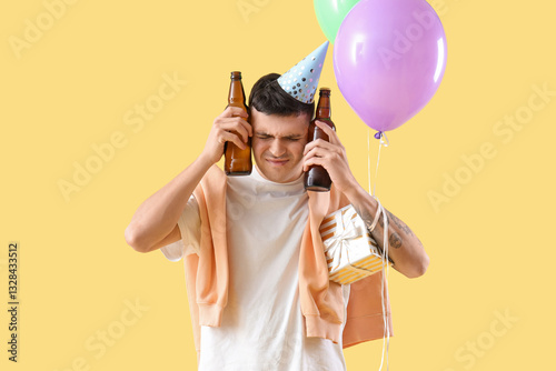 Young man with hangover and...