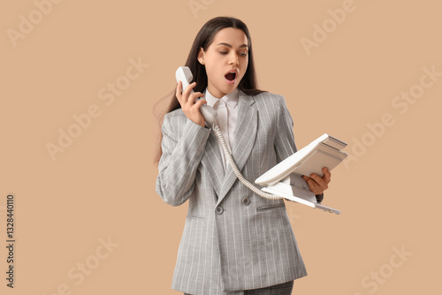 Shocked businesswoman talki...
