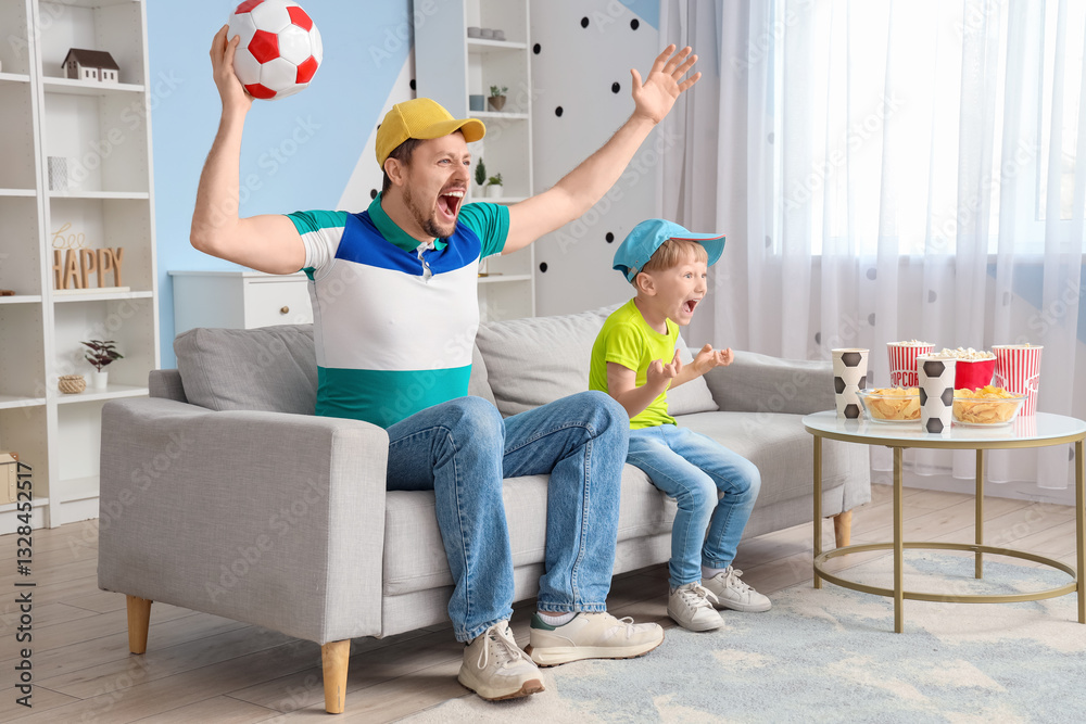 Fototapeta premium Young father and little son watching sports at home