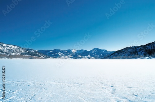 Wallpaper Mural Serene Winter Landscape with Vast Snow-Covered Lake and Majestic Mountains Under Clear Blue Sky in a Tranquil Outdoor Scene Torontodigital.ca