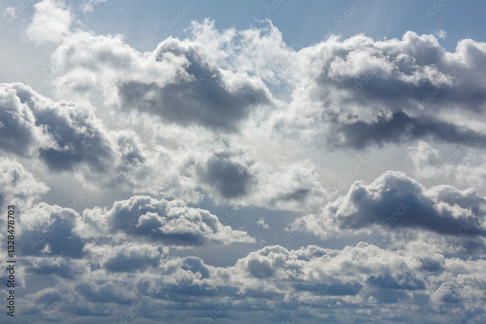 Fototapeta premium Dramatic cloudy sky with sunlight filtering through