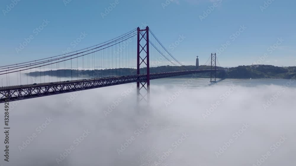 Drone shot of Ponte 25 Abril, in Lisbon. In fog.