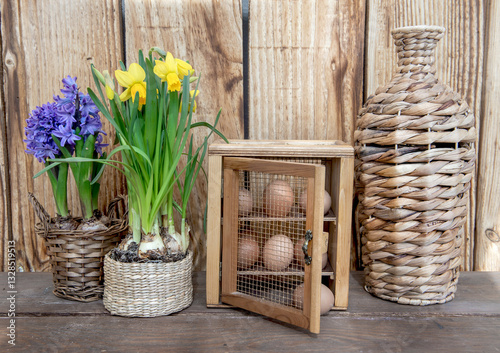 chicken eggs in a decorative box  put on a table next to flower potted and a ...