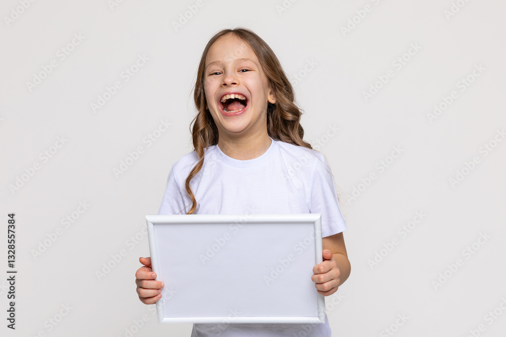 White empty banner. Laughing little school girl holds white blank paper. Young smiling woman show blank board. Close up female model portrait on white background. Mock up. Copy space. White empty banner. Laughing little school girl holds white blank paper. Young smiling woman show blank board. Close up female model portrait on white background. Mock up. Copy space.