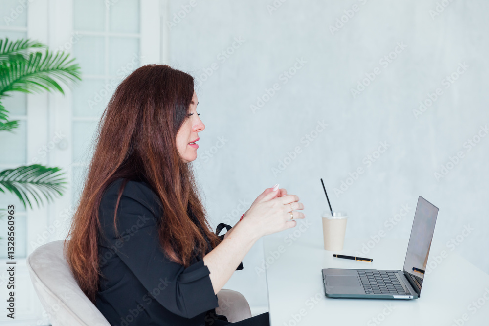 Businesswoman brunette sitting at desk surprised online laptop