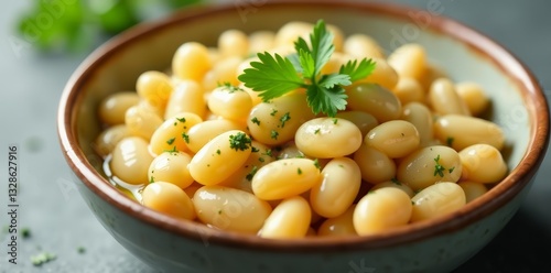 A close-up shot of a bowl of healthy white beans drizzled with olive oil and sprinkled with fresh herbs, food photography, close-up