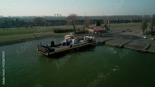 Drone view of a ferry in Scheur River, reaching the port of Rozenburg in Netherlands photo