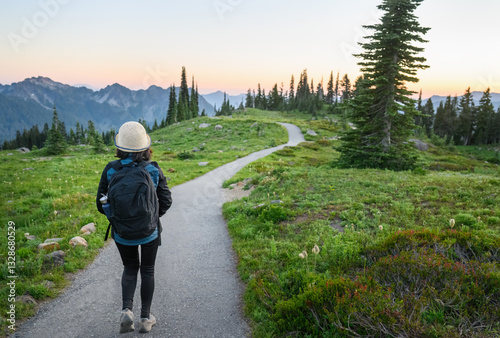 Obraz na płótnie Solo female traveler hiking Paradise at sunset. Mount Rainier National Park. Washington State. USA. w salonie