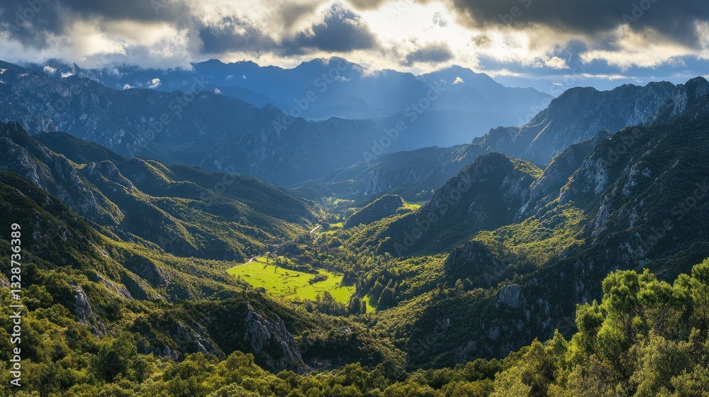 Fototapeta premium Majestic mountainous valley bathed in sunlight below the dark sky