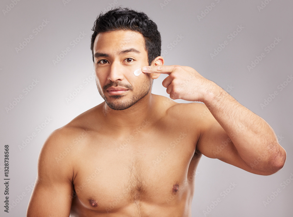 Beauty, moisturizer and portrait of man in studio to apply lotion for cosmetics or dermatology routine. Aesthetic, cream and skincare with shirtless model on gray background for antiaging cosmetology Beauty, moisturizer and portrait of man in studio to apply lotion for cosmetics or dermatology routine. Aesthetic, cream and skincare with shirtless model on gray background for antiaging cosmetology