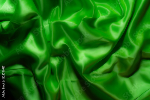 Vibrant green silky fabric with smooth folds and glossy texture. Ideal for luxury fashion, textile design, branding, nature-inspired themes, digital art, and eco-friendly product backgrounds
