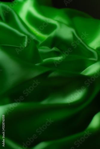 Vibrant green silky fabric with smooth folds and glossy texture. Ideal for luxury fashion, textile design, branding, nature-inspired themes, digital art, and eco-friendly product backgrounds