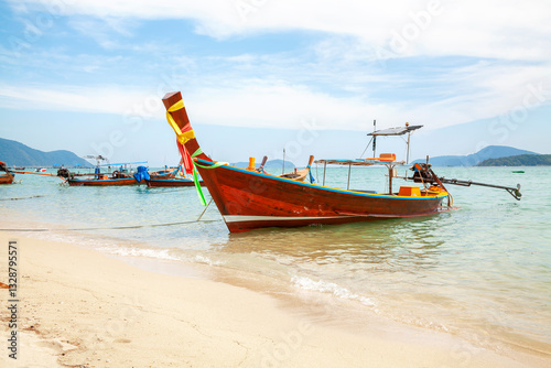 Obraz na płótnie Longtale boat on the beach at Phuket, Thailand. View of tropical beach near Phuket in Thailand. Travel summer concept. Vacation holidays summer background. Sea wooden boat in Thailand. w salonie