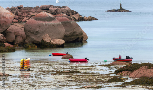 canoeing, kayaking and inflatable boats at low tide on Coz Pors beach, Trégastel, France photo