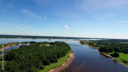 Wallpaper Mural The Daugava River stretches across the Latvian landscape, weaving between forested islands and sandy shores. The deep blue water reflects the clear sky in this peaceful, untouched setting. Torontodigital.ca