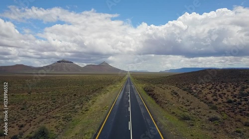 POV follows remote secondary highway on straight line thru arid desert