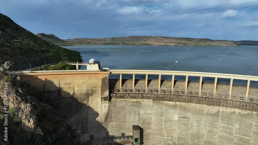 Golden hour aerial pulls out from Vanderkloof hydro electric power dam