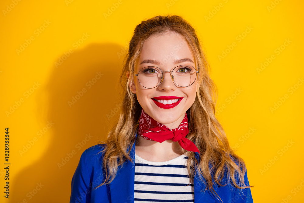 Smiling stylish young woman with blond hair against yellow background Smiling stylish young woman with blond hair against yellow background