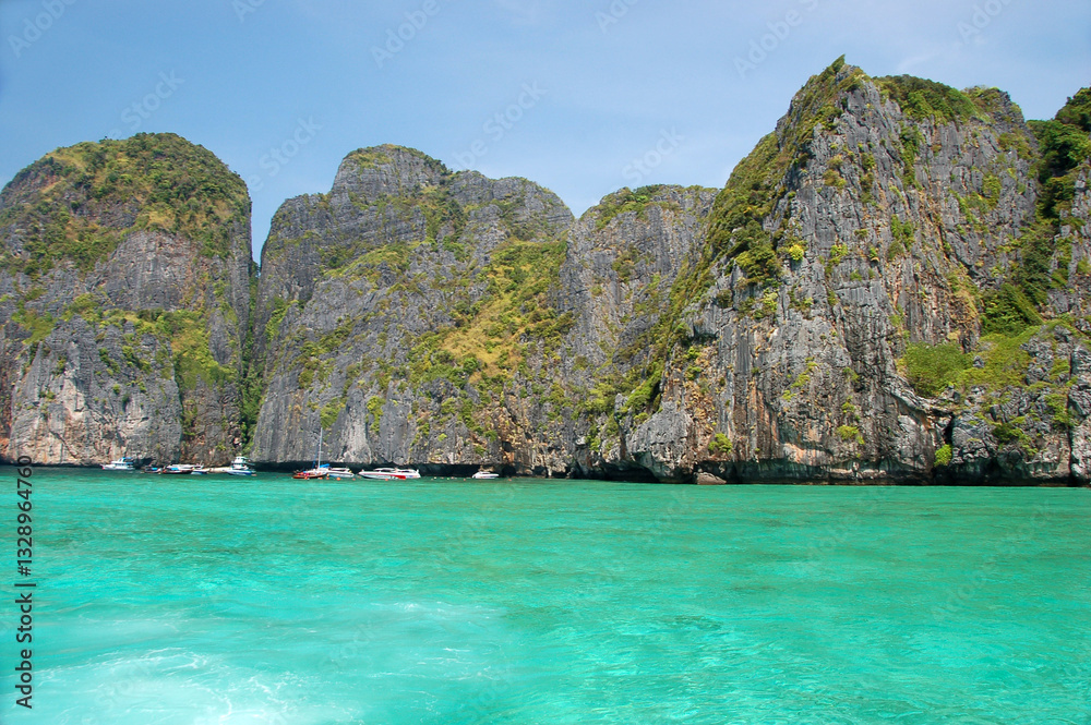 Limestone karst islands of Hong Island rise from the turquoise waters of the Andaman Sea under a clear blue sky in southern Thailand Limestone karst islands of Hong Island rise from the turquoise waters of the Andaman Sea under a clear blue sky in southern Thailand