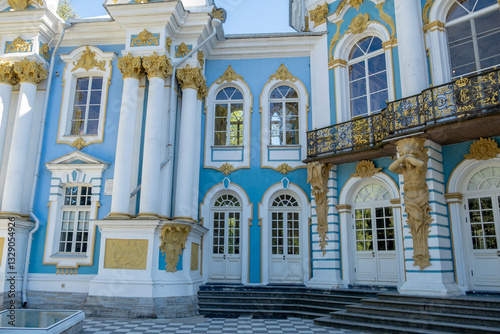 Marvel at the intricate architecture of Catherine Palace showcasing blue and gold details amid lush greenery in Russia