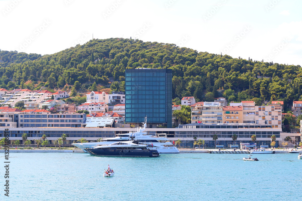 Contemporary buildings, gardens and beaches at the waterfront in Split, Croatia. View of Split from the boat.