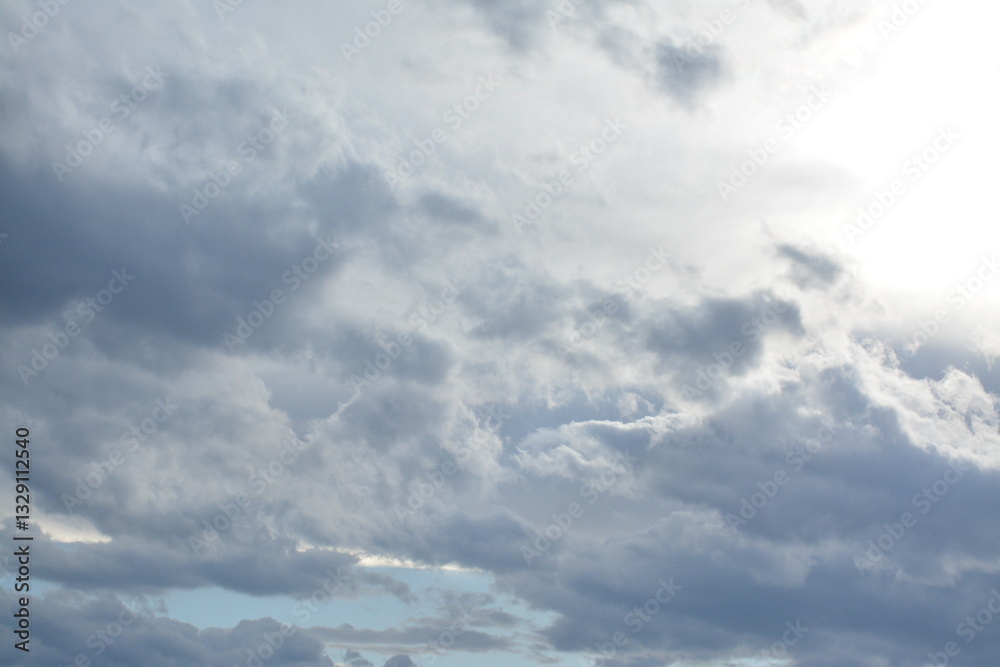 The sun is behind the clouds in the right corner of the background The sun is behind the clouds in the right corner of the background