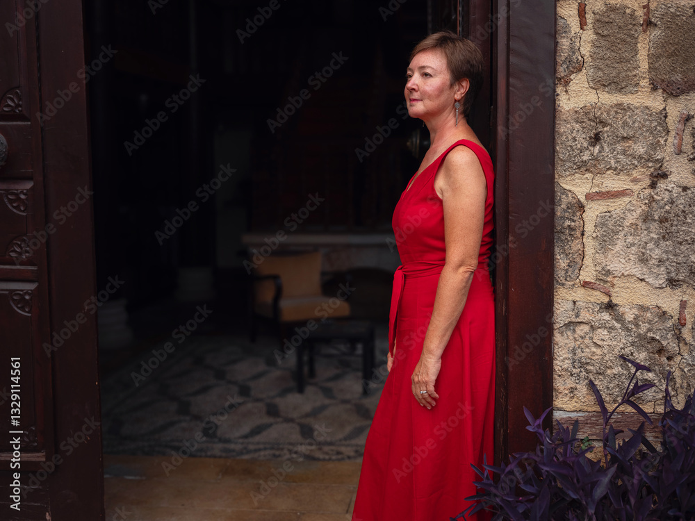 Woman in red dress walking narrow streets of old town Antalya during warm summer evening. Historic atmosphere and Mediterranean charm creates peaceful travel experience. view at old port and city Woman in red dress walking narrow streets of old town Antalya during warm summer evening. Historic atmosphere and Mediterranean charm creates peaceful travel experience. view at old port and city