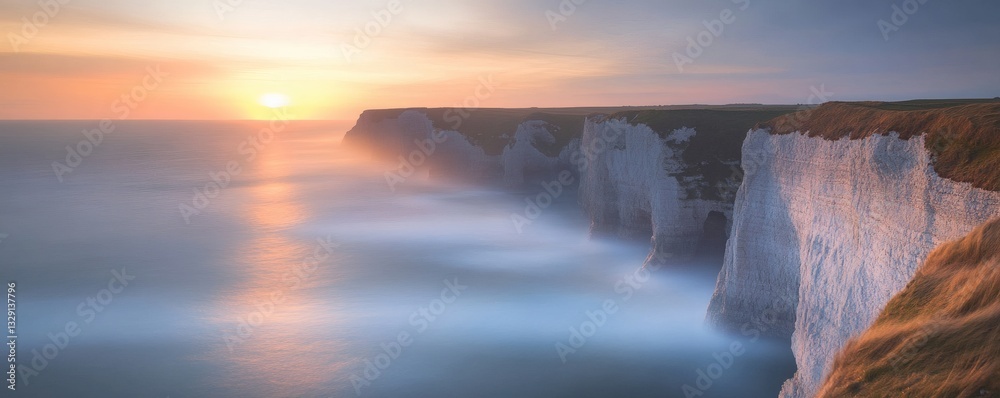 Fototapeta premium Dramatic coastal cliffs overlook the sea during a beautiful sunset