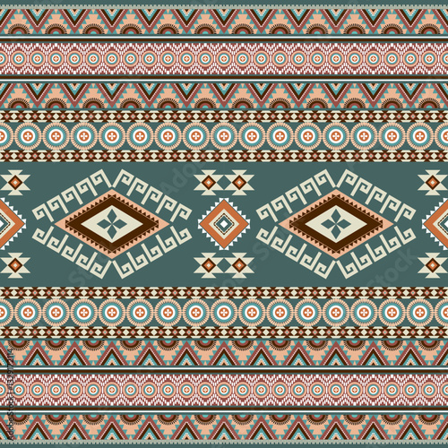 Abstract ethnic geometric texture pattern. Seamless yellow and orange color of tribal abstract fabric textile on pastel green background