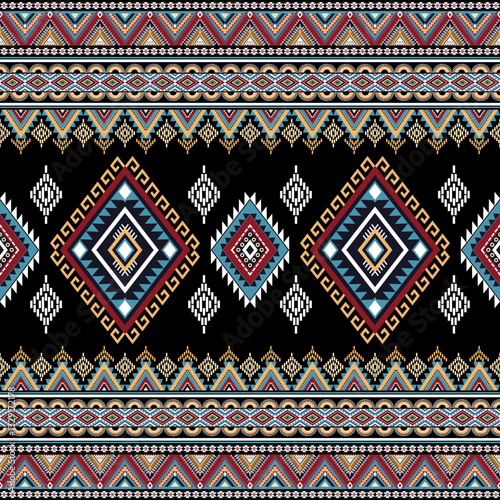 Abstract ethnic geometric texture pattern. Seamless red and yellow color of tribal abstract fabric textile on black background
